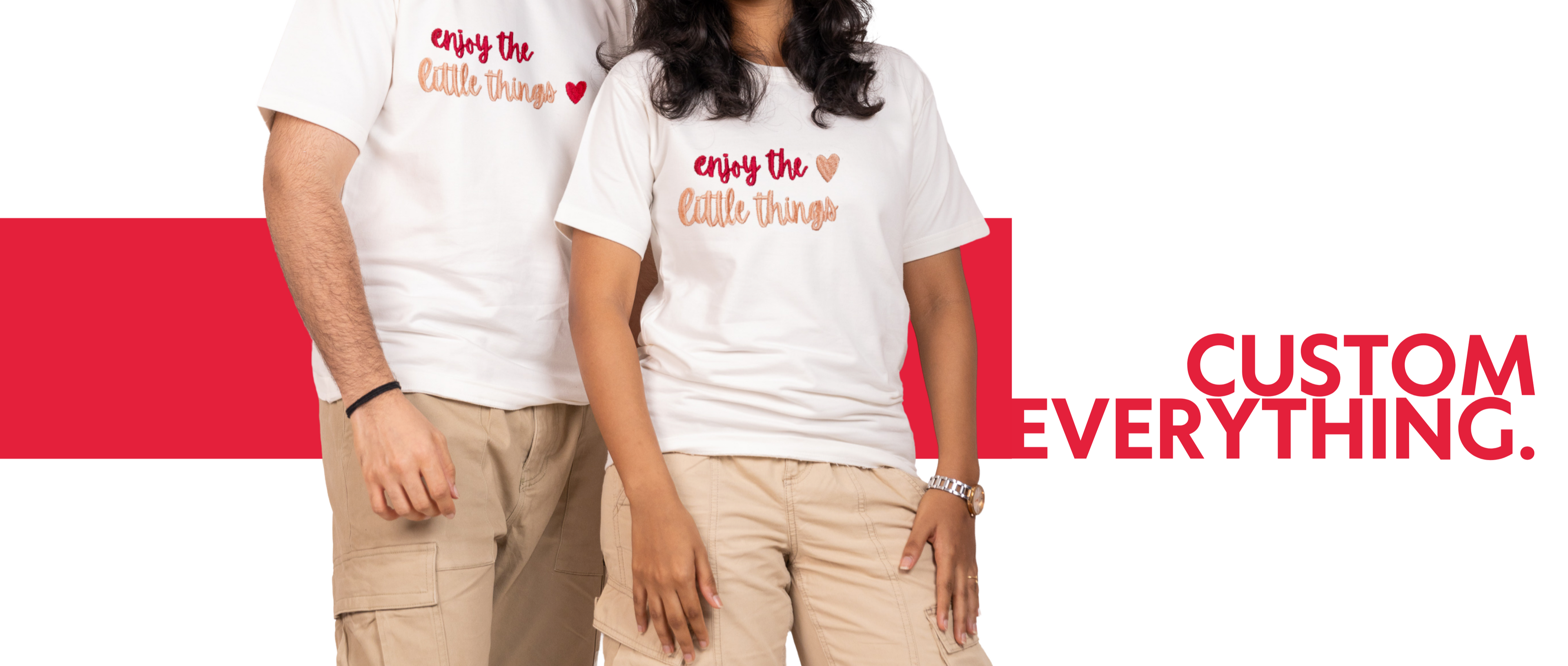 Two people wearing white t-shirts with text, standing against a red and white background with promotional text.